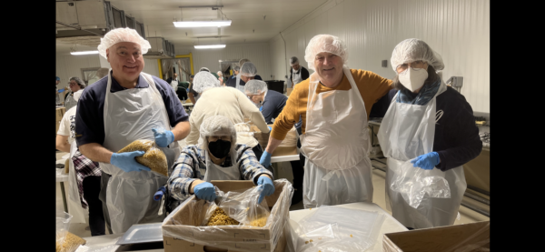 Main article image for story titled 'CLUB MEMBERS REPACKING FOOD AT THE FOOD BANK'